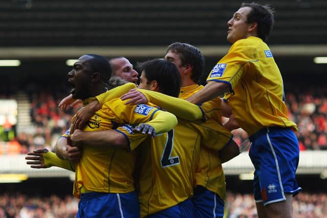 Richard Pacquette is mobbed after opening the scoring at Anfield in the FA Cup fourth round in January 2008. Photo by Mark Thompson/Getty Images.
