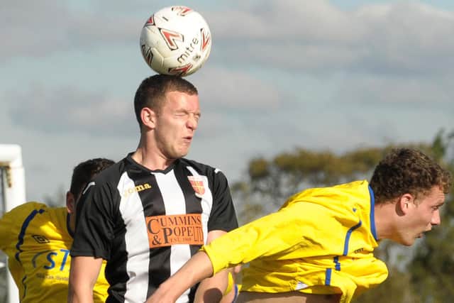 New AFC Portchester defender Luke Dempsey (stripes) in action during his Wessex League career at Hayling United. Pic Mick Young