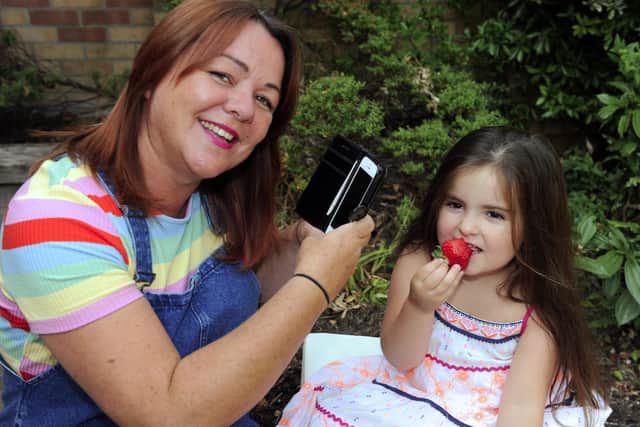 Kate Misselbrook, 50, who won The News' 2018 One Summer's Day photo competition with a photo of her goddaughter eating a strawberry. This is a recreation of that image. Picture: Malcolm Wells