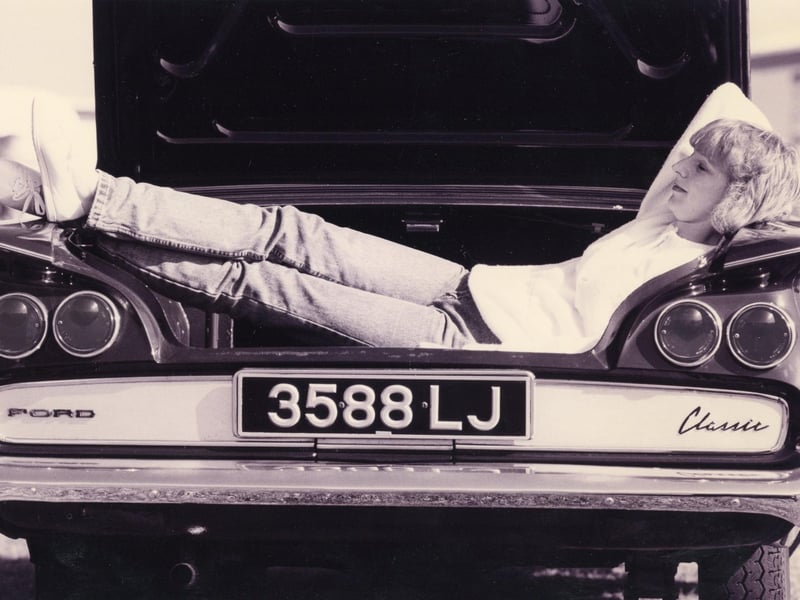 Janice Frost, 28, for Fareham takes a nap in her brothers Ford Classic at the Cortina owner's club rally in Gosport in 1993. The News PP3021
