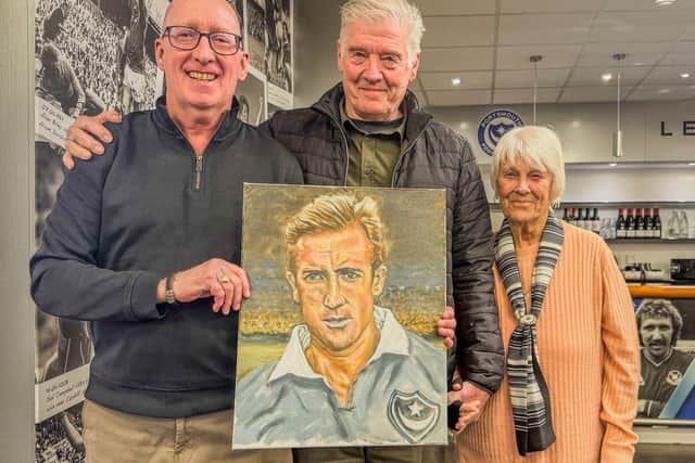 Bob Read (left) presents his portrait of Peter Harris to David & Mary Horne, who submitted the winning bid for it.