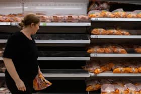 A woman walks past empty shelves that stock chicken at an Asda supermarket on September 19, 2021. Picture: Chris J Ratcliffe/Getty Images