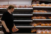 A woman walks past empty shelves that stock chicken at an Asda supermarket on September 19, 2021. Picture: Chris J Ratcliffe/Getty Images