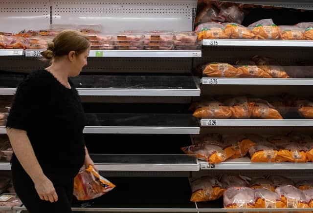 A woman walks past empty shelves that stock chicken at an Asda supermarket on September 19, 2021. Picture: Chris J Ratcliffe/Getty Images