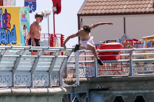 One child launches off South Parade Pier as another prepares to jump.
Photos by Alex Shute