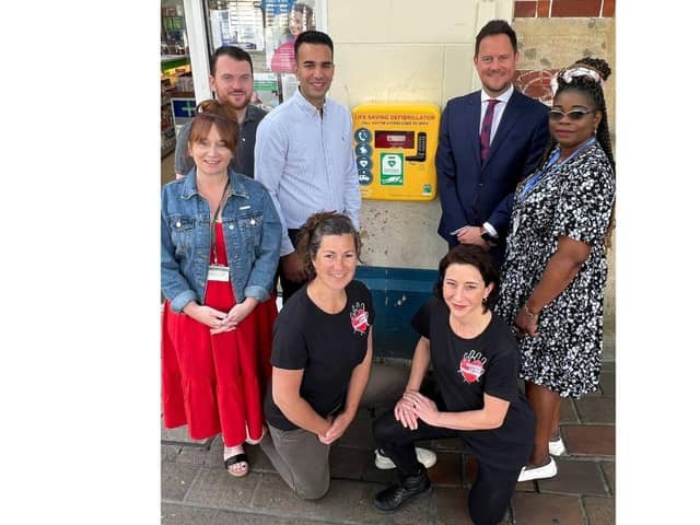 Saving Lives Together and Lalys Pharmacy partnered up to install a new defibrillator in Guildhall Walk

Pictured: STOOD: Councillors Kirsty Mellor and Carl Corkery for Charles Dickens Ward in Portsmouth, Director of Lalys Pharmacy Dr Raj Laly, Stephen Morgan MP for Portsmouth South, and Councillor Yinka Adeniran for Charles Dickens Ward.
KNELT: Founder of Saving Lives Together, Aisa Fraser with colleague and nurse, Ellie Batchelor