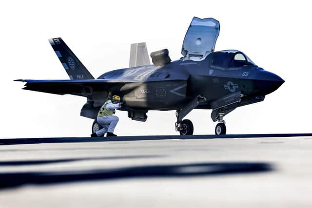 A Flight deck officer signals to the F35-B to launch. Picture: LPhot Fin Stainer-Hutchins.