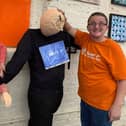 Make is holding its first ever urban scarecrow festival to honour key workers in Portsmouth. Pictured: Molly Bailey and Daniel Donovan, who are training in retail and catering with Make, with a scarecrow designed to thank police officers