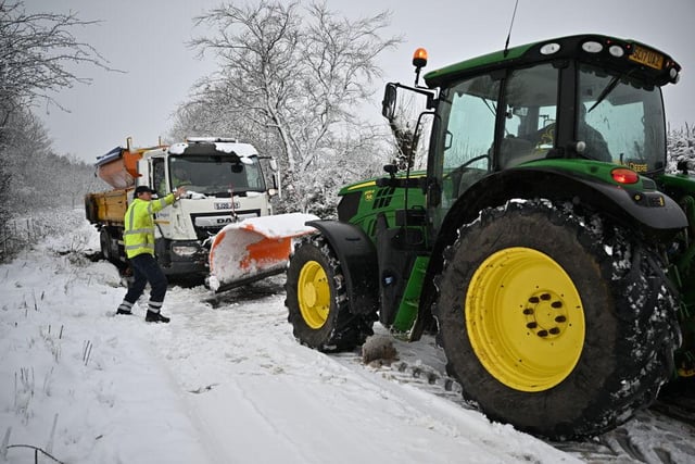 A snow plough receives assistance after coming off the road on Friday morning in Balfron, Scotland. The Met Office has issued two rare, red weather warnings for the South and South West of England as Storm Eunice makes landfall. (Photo by Jeff J Mitchell/Getty Images)
