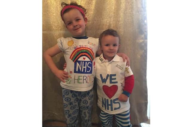 Five-year-old Vegas Edwards and her brother Leo, 3, wearing their home-made shirts showing appreciation for the NHS.