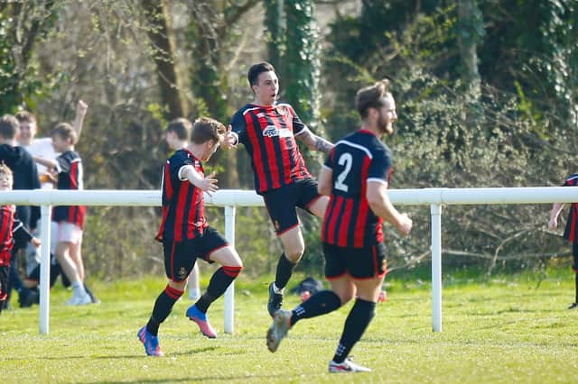 Brandon Rogers, middle, celebrates giving Fleetlands the lead against former club Moneyfields. Picture: Dave Bodymore