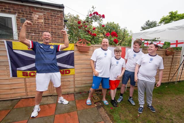 Darren Archer and his father in law, Cliff Williams will be on opposite side of the fence during England and Scotland's clash at the Euros tomorrow.

Pictured: Cliff Williams and Darren Archer with his children, Troy 12, Cody 15 and Reece 14 at Darren's home in Milton, Portsmouth on 17 June 2021

Picture: Habibur Rahman