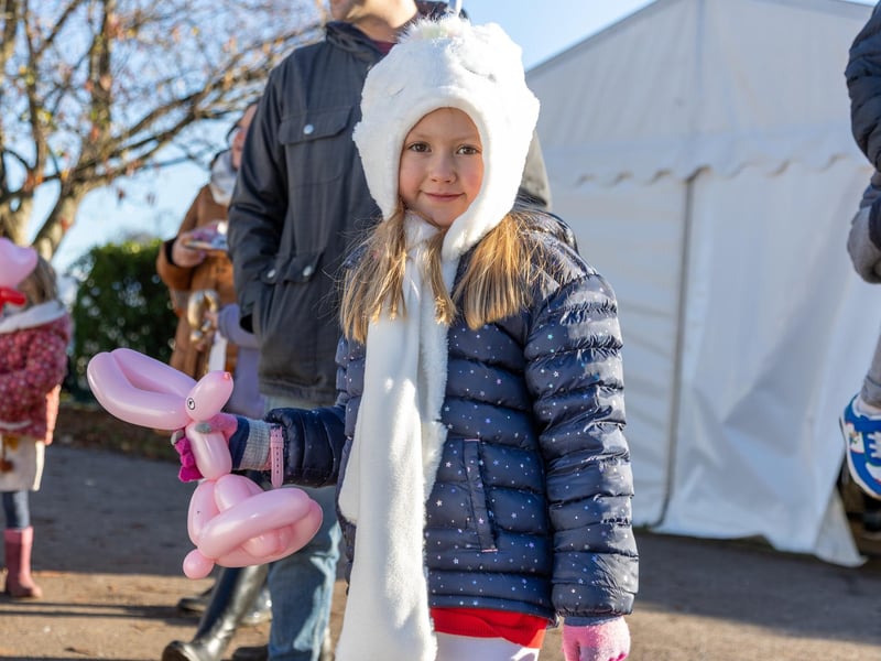 Pictured - Emmie Wetherall, seven, enjoying the balloon animals