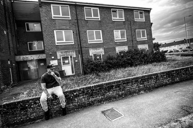 Parv on the cover of his debut album, Leigh Park, released on December 4, 2020. Behind him is Brent House, the supported housing scheme he lived in for a period.