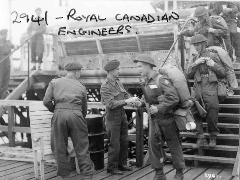 Royal Canadian Engineers on South Parade Pier, about to embark for Normandy, probably after D-Day. They appear to be being issued with something, maybe seasickness tablets?