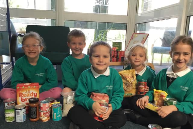 Hart Plain Infant School pupils with some of the food items donated to Waterlooville Foodbank. (Left to right) Gracie-Anne Blythe, Jack Ellis, Jared Brock, Khaleesi Mullineaux and Rebecca Lea, all aged 6.
