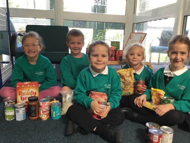 Hart Plain Infant School pupils with some of the food items donated to Waterlooville Foodbank. (Left to right) Gracie-Anne Blythe, Jack Ellis, Jared Brock, Khaleesi Mullineaux and Rebecca Lea, all aged 6.