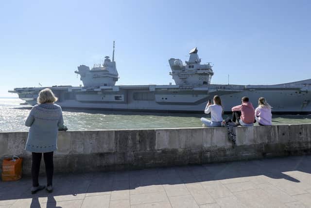 Members of the public watch the HMS Prince of Wales arriving  back at Portsmouth Naval Base. Photo: Steve Parsons/PA Wire