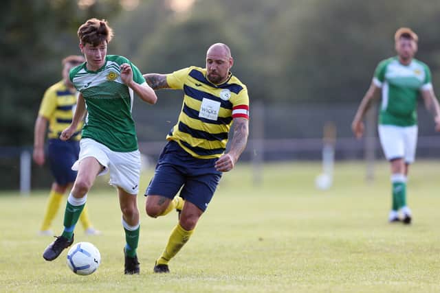 Paulsgrove's Aaron Fennemore gives chase to Moneyfields' Chad Cornwell. Picture: Chris Moorhouse