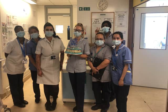 Some of the staff in ward D4 at Queen Alexandra Hospital in Cosham with the cake that was donated by The Cheesecake Vault.