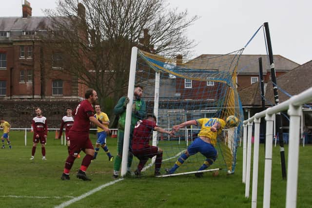 Dale Holmes ends up in the back of the net after scoring one of his four goals against Netley. Picture: Andy Nunn