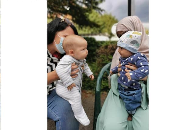 Alexandra Kenchington, left, with her four-month old son, Barney, looking at the four-month old daughter, Madiha, of Afghan refugees. The doctor has been volunteering with Ems4Afghans, a community-based organisation that supports other agencies and Afghan refugees Picture: Matt Simmons/PA Wire