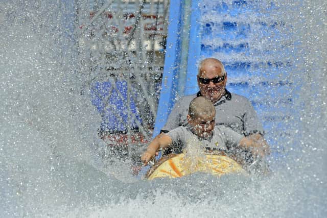 Maciej Ciarach and his grandson Alan, 10, enjoy the new log flume ride.

Picture Ian Hargreaves (180720-2)