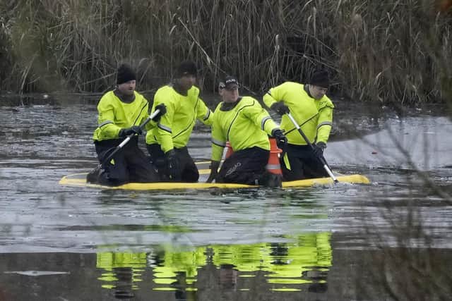 Emergency workers during a search for further victims after a number of children fell through ice on a lake,  on December 12, 2022 at Babbs Mill Park in Solihull, England. Photo by Christopher Furlong/Getty Images.
