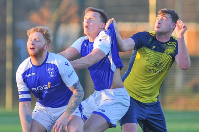 Denmead (blue/white) in action during last weekend's 2-0 Hampshire Premier League win over leaders Moneyfields. Picture: Martyn White