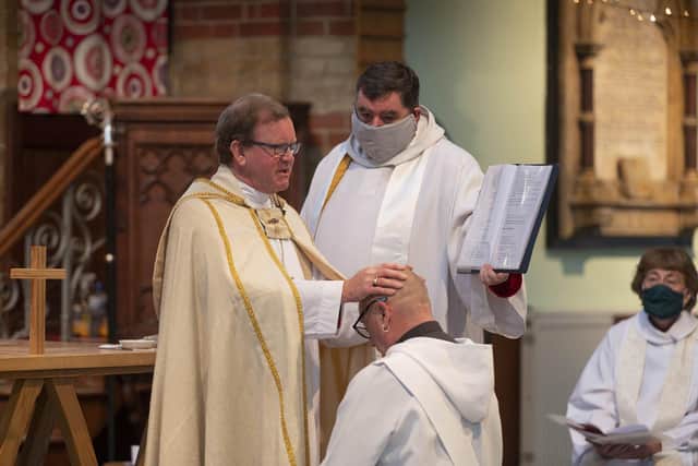 Bishop Christopher Foster ordains the Rev Bryan Stephenson as a priest, with area dean of Portsmouth Canon Bob White, at St Luke's Church, Southsea
