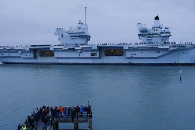 Clips from the pair's music video capture HMS Queen Elizabeth returning home to Portsmouth.