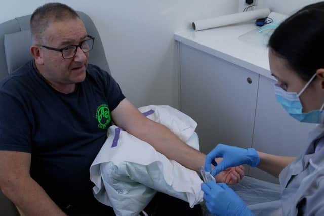Adam Jackson gives blood to see if it holds vital clues about detecting lung cancer earlier.