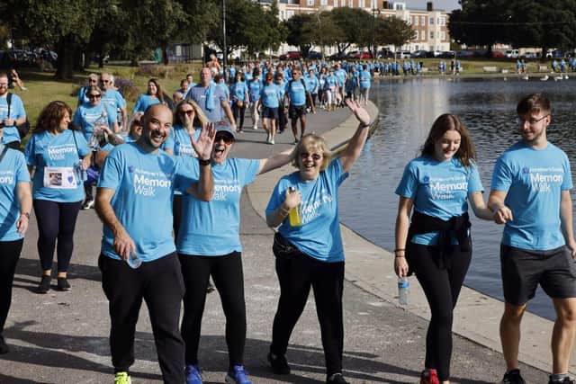 Memory Walkers waving as they follow route around Canoe Lake