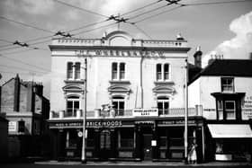 The cat's cradle of trolley bus wires outside The Wheelbarrow pub at 1 Kent Road, Southsea, Portsmouth in 1960