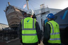 Vinci technicians working to clean the HMS Victory dry dock, at Portsmouth Historic Dockyard. Picture by Steve Reigate