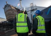 Vinci technicians working to clean the HMS Victory dry dock, at Portsmouth Historic Dockyard. Picture by Steve Reigate