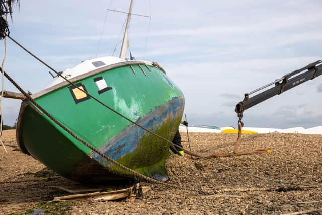 Pictured - Abandoned boats being removed by Langstone Harbour Board, along with boats whose owners have agreed to scrap.
Photos By Alex Shute