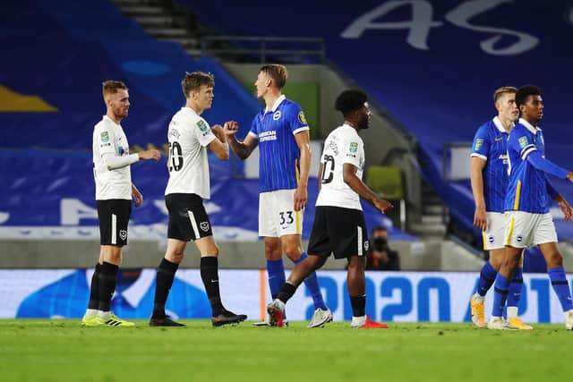 Pompey's Ellis Harrison and Portsmouth's Sean Raggett  after the defeat to Brighton. Picture: Joe Pepler