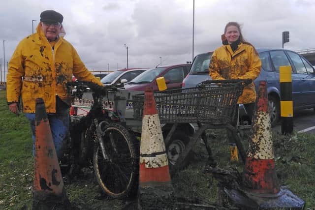 Friends of Langstone Harbour cleaned up the harbour near the Eastern Road roundabout. Pictured: John Worley and granddaughter Scarlett Sprague with objects wrestled from deep harbour mud