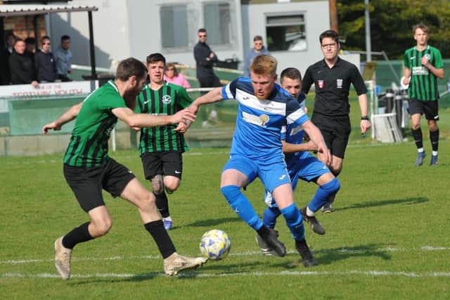 Harvest (blue) in action during their HPL Supplementary Cup semi-final win at Andover New Street Swifts. Picture: Ian Grainger.