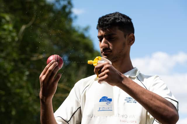 Shahryar Kahn, seen here disinfecting the ball last summer, bagged a career best 5-14 as Hambledon defeated Purbrook in SPL Division 3. Picture: Jordan Pettitt/Solent News & Photo Agency.