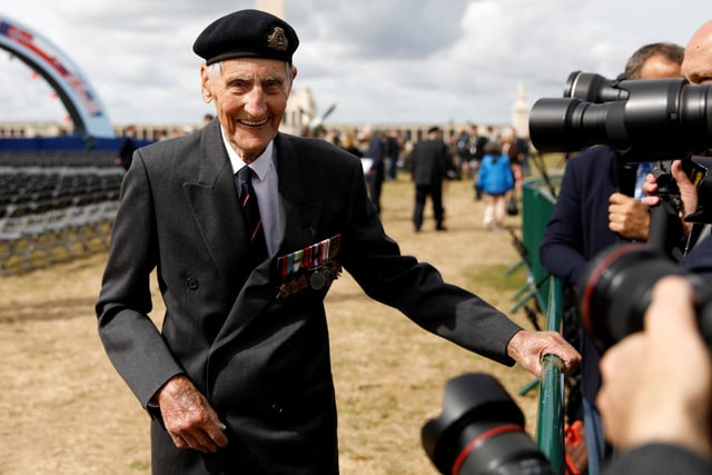 Former British Royal Marine, and D-Day veteran Jim Booth, reacts as he poses for a photograph
