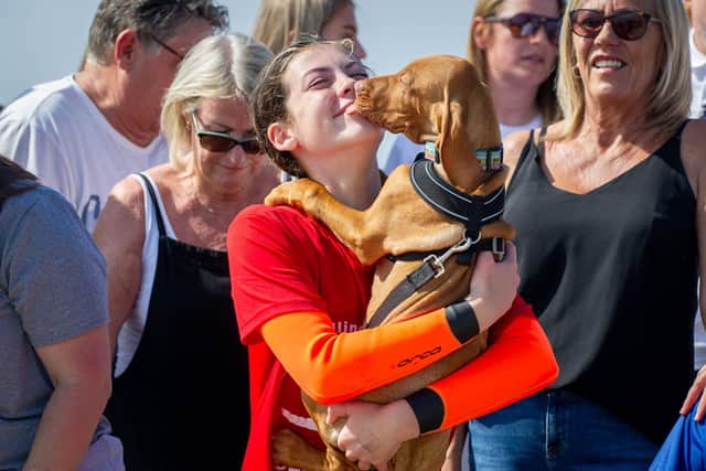12-year-old Seren Killpartrick from Fareham is paddleboarding from the Isle of Wight to Stokes Bay to raise money for brain tumour treatment for her dad.Pictured: Seren Killpartrick with her dog, Buzz at Stokes Bay beach on Thursday 16th September 2021Picture: Habibur Rahman
