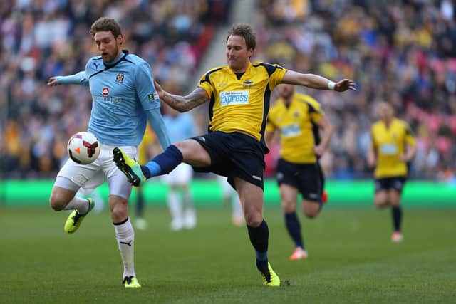 Gosport Borough's Sam Pearce and Cambridge United's Ryan Bird compete for the ball