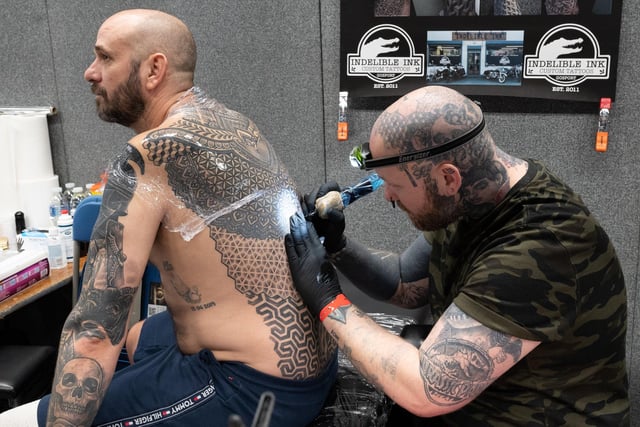 Pictured is: Jen Bradley tattoos Wayne Huggitt with an intricate pattern
Picture: Keith Woodland (010421-34)