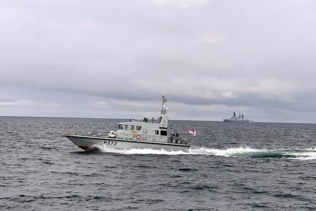 HMS Smiter with HMS Defender in the background