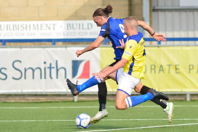Clanfield's Charlie McNally (blue). Picture: Martyn White.