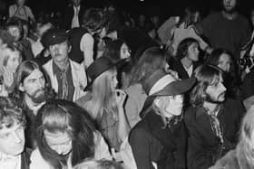 John Lennon, centre, George Harrison, left, and his wife, model, photographer and author, Pattie Boyd, and Ringo Starr, front, in the crowd at the 1969 Isle of Wight Festival. Picture: William Lovelace/Daily Express/Hulton Archive/Getty Images.