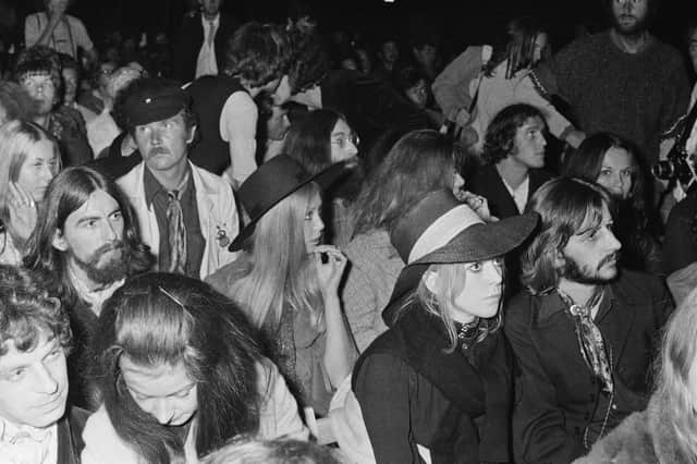John Lennon, centre, George Harrison, left, and his wife, model, photographer and author, Pattie Boyd, and Ringo Starr, front, in the crowd at the 1969 Isle of Wight Festival. Picture: William Lovelace/Daily Express/Hulton Archive/Getty Images.
