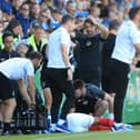 Pompey midfielder Louis Thompson receives treatment following a tackle from Glenn Whelan during Saturday's win against Bristol Rovers